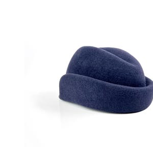 rear angle of the hat showing the back curve of the molded ear flap, highlighting the subtle slope of the crown