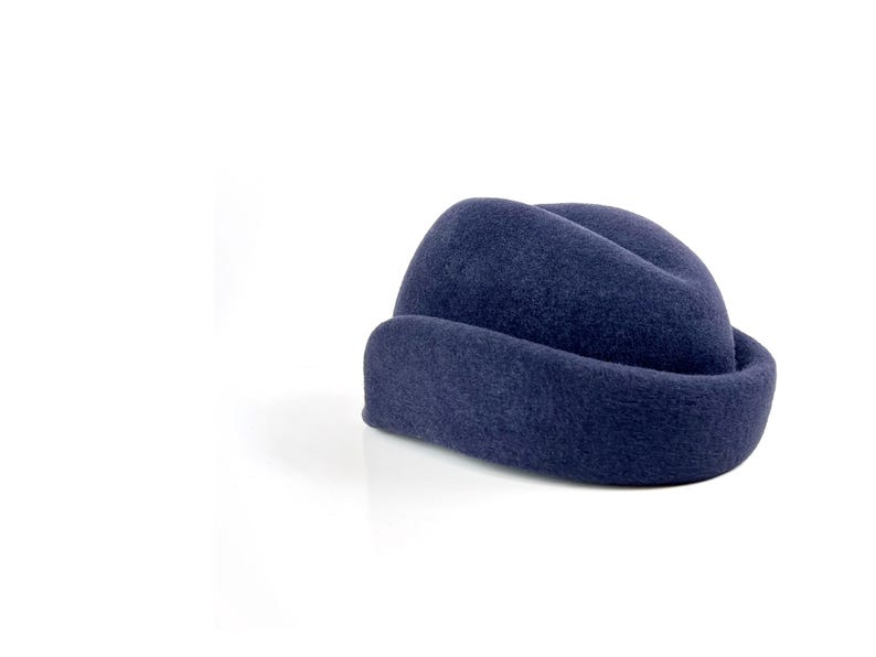 rear angle of the hat showing the back curve of the molded ear flap, highlighting the subtle slope of the crown