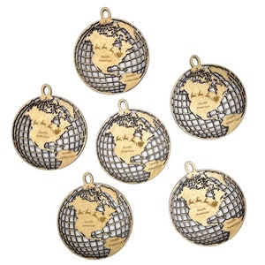 May include: Six wooden globe ornaments with a grid pattern and the words "North America" and "South America" inscribed on each. The globes are a light brown color and have a gold finish.