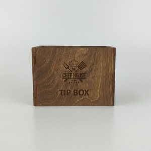 May include: A wooden tip box with the text "The Chef House Est. 2017" and "Tip Box" engraved on the front.