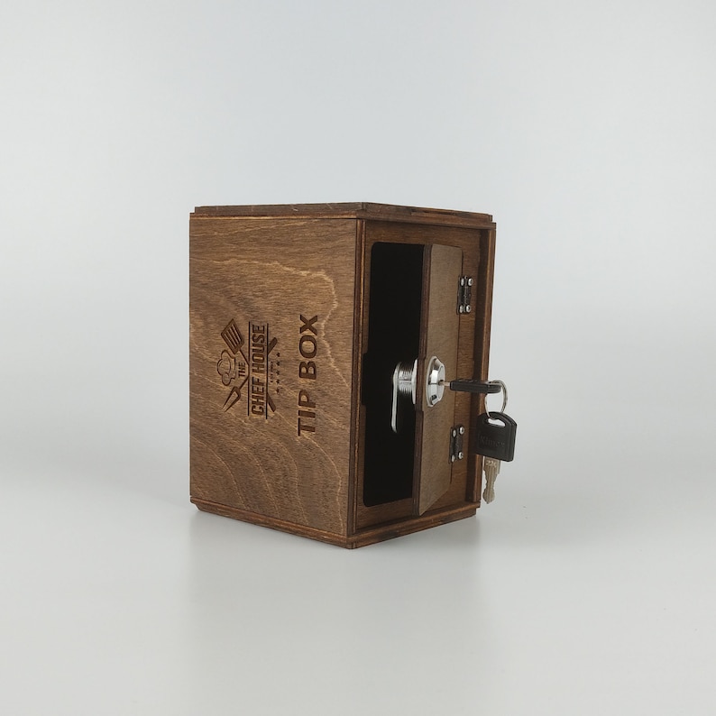 May include: A wooden tip box with a lock and key. The box is labeled "The Chef House Tip Box".