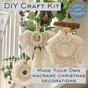 May include: DIY craft kit to make your own macrame Christmas decorations. The kit includes white macrame cord, wooden beads, and instructions. The image shows three finished decorations: a star, an angel, and a circle.