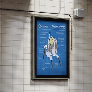 May include: A framed poster on a tiled wall features a blueprint-style diagram of an Aperture Science Sentry Turret. The diagram is on a blue background with white text and lines, showing the internal components of the turret.