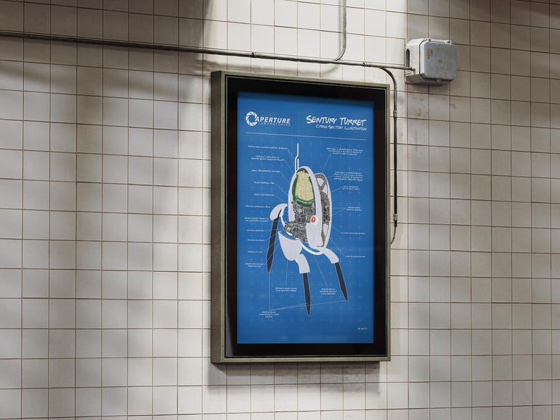 May include: A framed poster on a tiled wall features a blueprint-style diagram of an Aperture Science Sentry Turret. The diagram is on a blue background with white text and lines, showing the internal components of the turret.