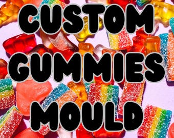 May include: A vibrant mix of gummy sweets in diverse shapes and colours, including red, yellow, blue, and rainbow-striped gummies. The text "CUSTOM GUMMIES MOULD" is displayed in a bold, black font with a white outline against a purple background.