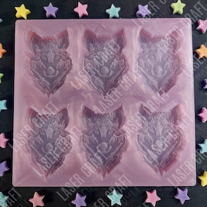 May include: A purple silicone mold with six wolf head designs. The mold is designed for making resin crafts.