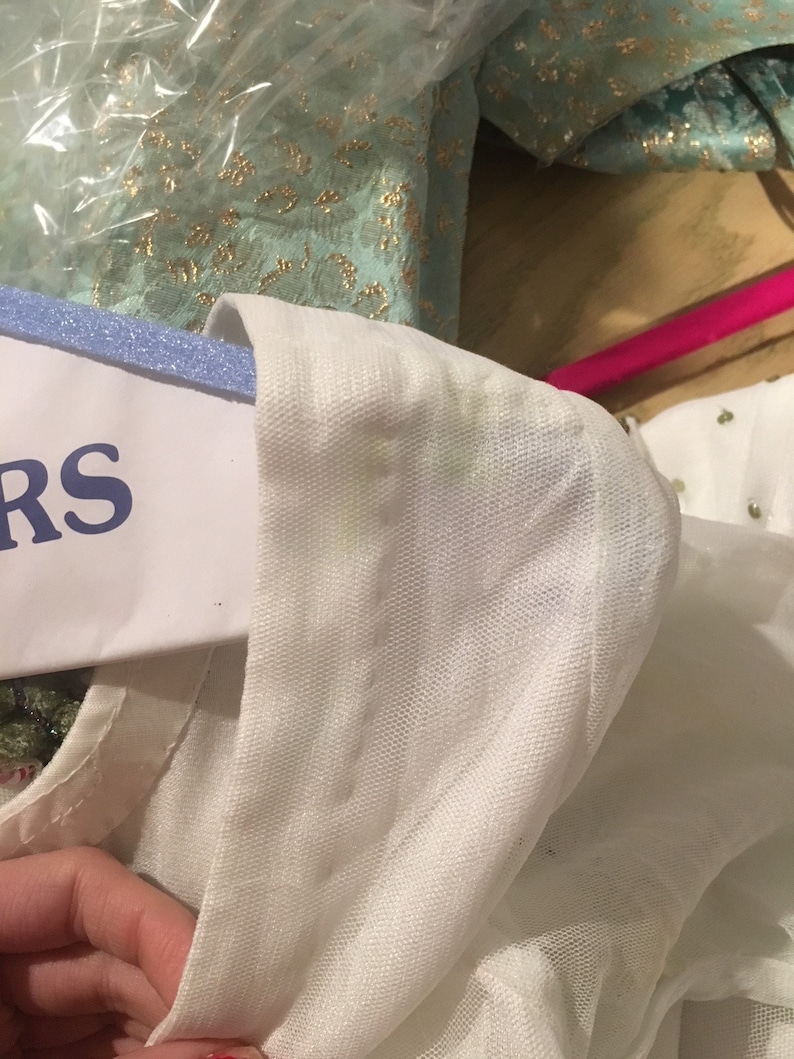May include: White mesh fabric with a white trim. The fabric is slightly wrinkled and has a few small stains.