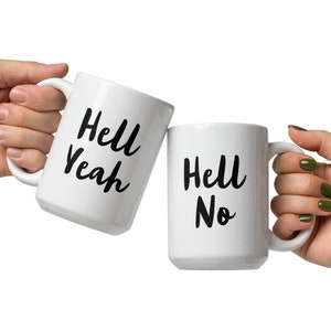 May include: Two white ceramic mugs with black lettering. One mug says "Hell Yeah" and the other says "Hell No".