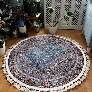 May include: A round blue and red patterned rug with white fringe. The rug has a geometric design with a central medallion.