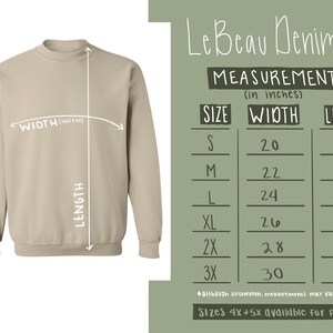 May include: Size chart for a beige sweatshirt with measurements in inches. The chart shows the width and length of the sweatshirt in sizes S, M, L, XL, 2X, and 3X. Sizes 4X and 5X are available for pre-order.