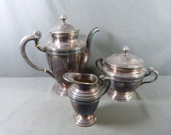 ERCUIS French Tea service in silver plated metal : teapot, milk jug, sugar bowl , all with molded decoration.