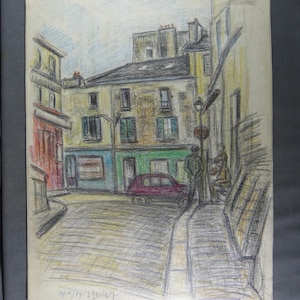May include: A black and white pencil drawing of a street scene in a European city. The drawing depicts a narrow street with buildings on either side. There is a car parked in the street and two people walking in the distance. The drawing is signed "14/10 '59 A. Bouley"