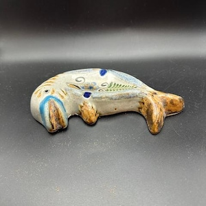 May include: A set of three ceramic mugs with a speckled, matte finish. The mugs are in shades of cream, light gray, and dark gray. Each mug has a simple, minimalist design and a rounded handle.