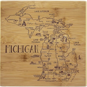 May include: A wooden cutting board with a laser-etched map of Michigan. The map includes major cities, lakes, and geographic features. The board is made of bamboo and has a natural wood finish.