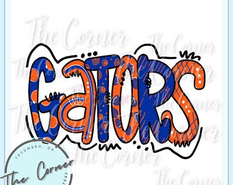May include: A colorful graphic design of the word "GATORS" in orange, blue, and white. The letters are outlined in black and have a variety of patterns and designs.