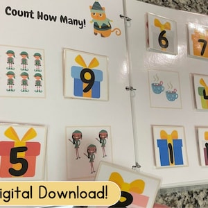 May include: A colorful counting book with images of elves, presents, and hot chocolate. The book has the title "Count How Many!" and features numbers 1 through 10.