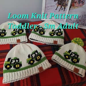 May include: Four knitted hats with a tractor design. The hats are in different sizes: toddler, small, and adult. The hats are white with green and black accents. The text "Loom Knit Pattern Toddler Sm Adult" is displayed above the hats.