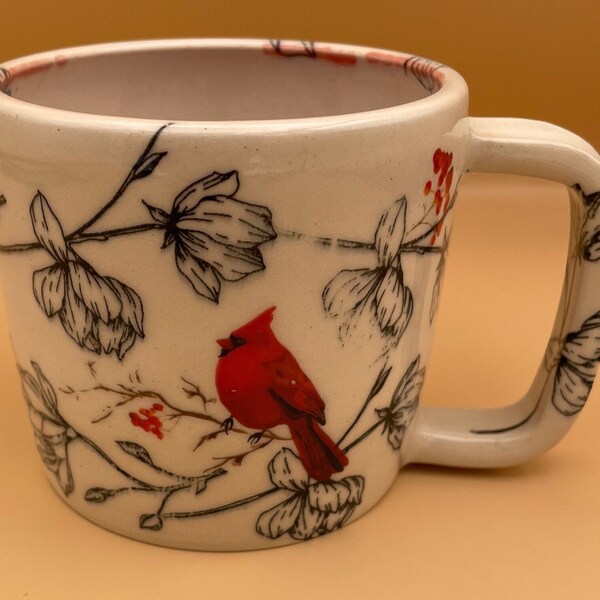 Ceramic marbleized pottery coffee mug, snow cardinals on flower backdrop. 16 oz.