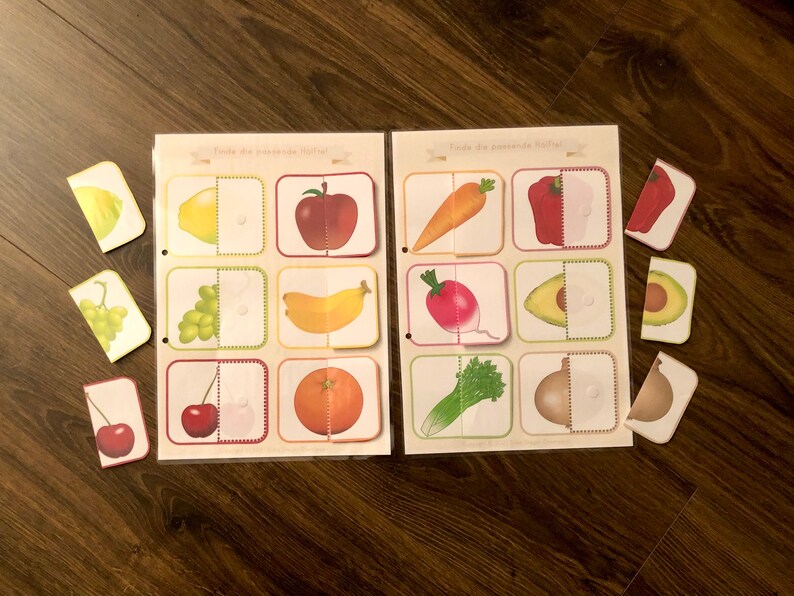 May include: A set of matching game cards featuring various fruits and vegetables. The cards are divided in half, with one half showing the whole fruit or vegetable and the other half showing a cut-out section. The cards are labeled "Tilda the awesome fruit!" and "Tilda the awesome veggie!"