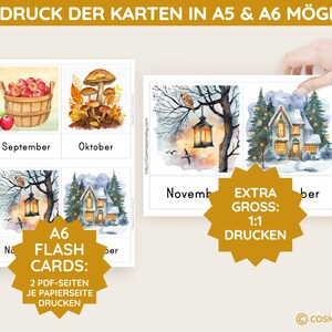 May include: A set of four illustrated flash cards featuring images of a basket of apples, mushrooms, a lantern hanging from a tree branch, and a snow-covered house. The cards are labeled with the months September, October, November, and December. The text "A6 Flash Cards: 2 PDF-Seiten je Papierseite Drucken" is printed on a gold starburst shape. The text "EXTRA GROSS: 1:1 DRUCKEN" is printed on a gold starburst shape.