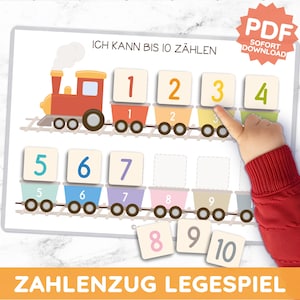 May include: Educational counting game featuring a colorful train with numbered train cars. The game includes number tiles from 1 to 10. The text "ICH KANN BIS 10 ZÄHLEN" is at the top, and "ZAHLENZUG LEGESPIEL" is at the bottom.