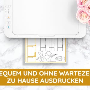 May include: A white printer with a sheet of paper coming out of it. The paper has a black and white illustration of a dragonfly, balloons, and a hot air balloon. The text on the paper says "BEQUEM UND OHNE WARTEZEIT ZU HAUSE AUSDRUCKEN".