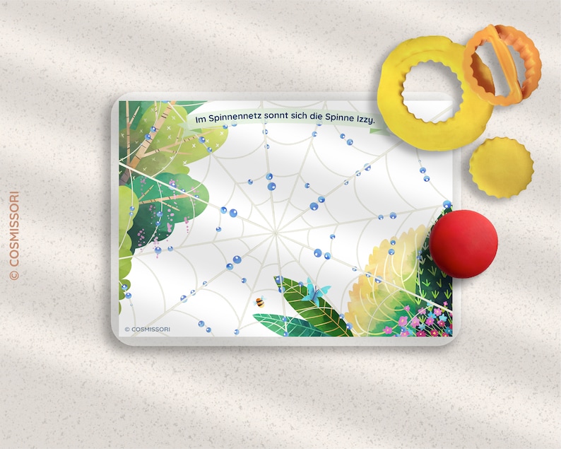 May include: A colorful learning game with a spider web design, featuring a bee, a butterfly, and blue beads. The game includes a red ball, a yellow ring, and a yellow circle.