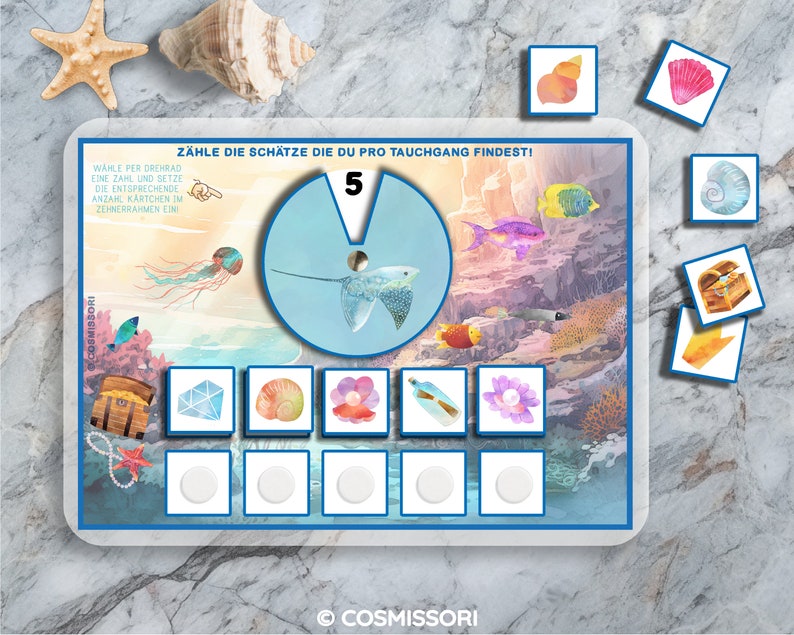 May include: A colorful underwater scene with a stingray, fish, and treasure chests. The game board includes a spinner with the number 5 and a section for counting treasures. The game is called "Z&auml;hle die Sch&auml;tze die du pro Tauchgang findest!" which translates to "Count the treasures you find per dive!"