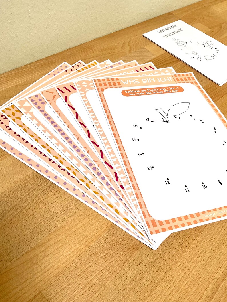 May include: A set of 10 printable worksheets with a connect-the-dots activity. The worksheets feature a variety of colorful patterns and the text "WAS BIN ICH?" which translates to "What am I?" in English. The instructions ask the user to connect the dots from 1 to 17 and then color the finished picture.