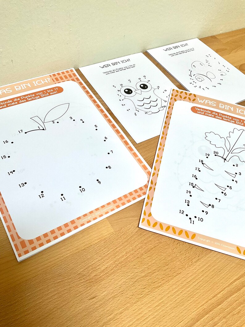 May include: Three printable dot-to-dot activity sheets with a brown and orange checkered border. The sheets feature a leaf, an owl, and a bee. The text on the sheets reads "Wer bin ich?" and "Was bin ich?" which translates to "Who am I?" and "What am I?" in English.