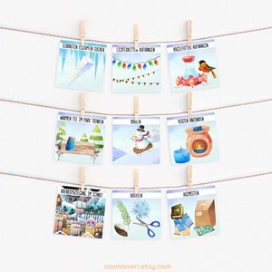 May include: Nine illustrated cards with winter activities in German. The cards are hung on a string with clothespins. The activities include searching for icicles, hanging lights, putting out bird feeders, drinking hot tea, sledding, lighting candles, taking an evening walk, crafting, and cleaning out.