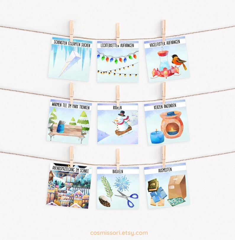 May include: Nine illustrated cards with winter activities in German. The cards are hung on a string with clothespins. The activities include searching for icicles, hanging lights, putting out bird feeders, drinking hot tea, sledding, lighting candles, taking an evening walk, crafting, and cleaning out.