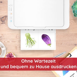 May include: A white printer with a sheet of paper in the tray. The paper has two images of vegetables: a green fennel and a purple eggplant. The text on the paper says "Ohne Wartezeit und bequem zu Hause ausdrucken".