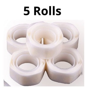 May include: Five rolls of white double-sided adhesive tape.