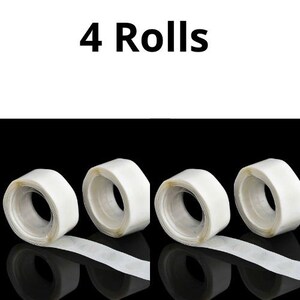 May include: Four rolls of clear double-sided adhesive tape. The tape is on a white background.