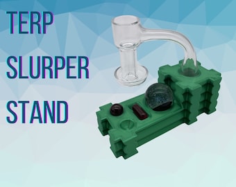 May include: Green terp slurper stand with a glass banger and marble. The stand has a small red marble and a red rectangle on the top.