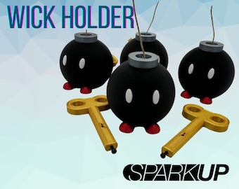 May include: Four black bob-omb shaped wick holders with red and white accents. Each holder has a small hole on top for a wick. Two gold keys are included.