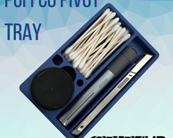 May include: A blue tray with compartments for storing a Puffco Pivot, cotton swabs, and a small tool. The tray is made of a textured material and has the word "SPARKUP" printed on the bottom.