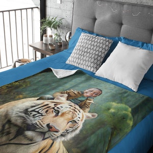 May include: A blue fleece blanket featuring a printed image of a tiger with a person riding on its back. The image is set against a green and blue background.