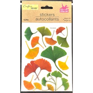 May include: A sheet of 14 stickers featuring ginkgo leaves in various shades of green, yellow, and orange. The stickers are labeled "stickers autocollants" and "Magic-On Magie-Sur".