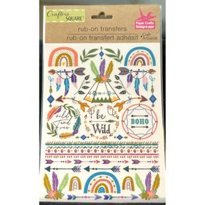May include: A sheet of rub-on transfers featuring a variety of bohemian-themed designs, including arrows, feathers, rainbows, tipis, and the phrases "wild and free", "be wild", and "boho".