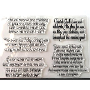 May include: A white ceramic mug with a black handle and the text "But First, Coffee" in a bold, black font. The mug is set against a blurred background, suggesting a cozy setting.