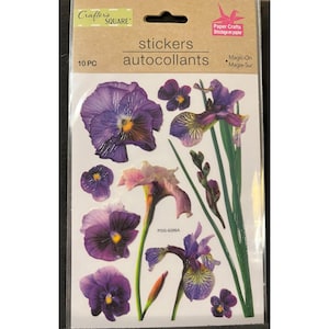 May include: A sheet of 10 purple and green flower stickers. The stickers feature irises and pansies. The text "stickers autocollants" is printed on the sheet.