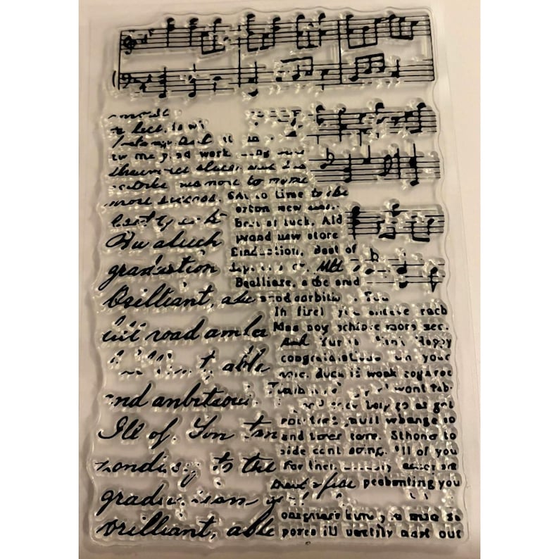 May include: Clear, rectangular stamp with musical notes and handwritten script. The script includes words like "graduation" and "brilliant." Ideal for crafting and scrapbooking projects.