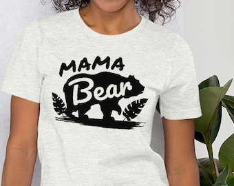 May include: A white t-shirt with a black silhouette of a bear and the text "Mama Bear" printed on the front.