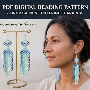 May include: A pair of blue, white, and teal beaded fringe earrings. The earrings are displayed on a gold stand. The text on the image reads "PDF DIGITAL BEADING PATTERN 2-DROP BRICK STITCH FRINGE EARRINGS" and "Mountain to the sea."
