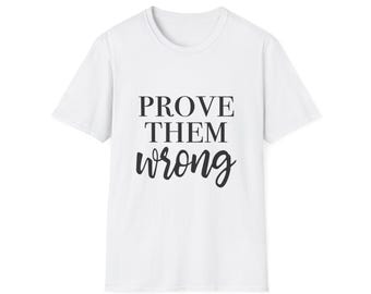 May include: A white t-shirt with the text "PROVE THEM wrong" in black. The text is arranged in three lines, with the word "wrong" in a cursive font. The shirt has short sleeves and a crew neck.