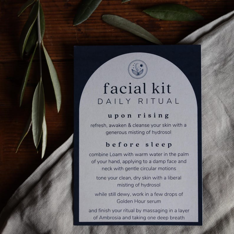 May include: A blue and white card with the text "facial kit DAILY RITUAL" and instructions for a daily skincare routine. The instructions include steps for "upon rising" and "before sleep".