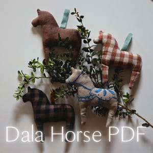 May include: Four handmade Dala horse ornaments in various patterns and colours, including brown, plaid, and tan. Each horse has a loop for hanging and is decorated with blue accents. The text "Dala Horse PDF" is at the bottom.