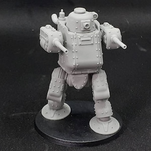 May include: A grey, detailed, plastic model of a walking tank with two cannons. The tank has a round, domed top and a rectangular body. The tank is standing on a black base.